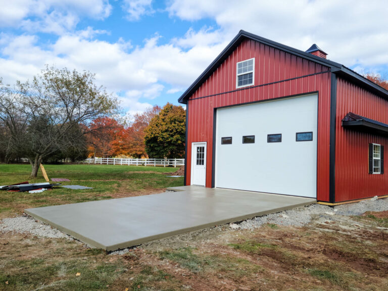 red 12x20 pole barn with white garage door