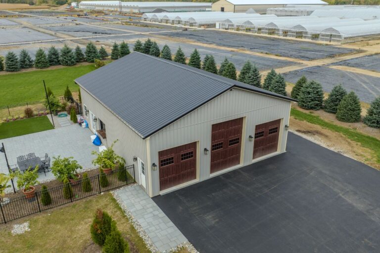A garage pole barn with three brown garage doors in Phillipsburg, NJ